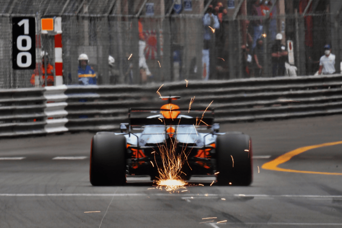 a man driving a racing car on a race track