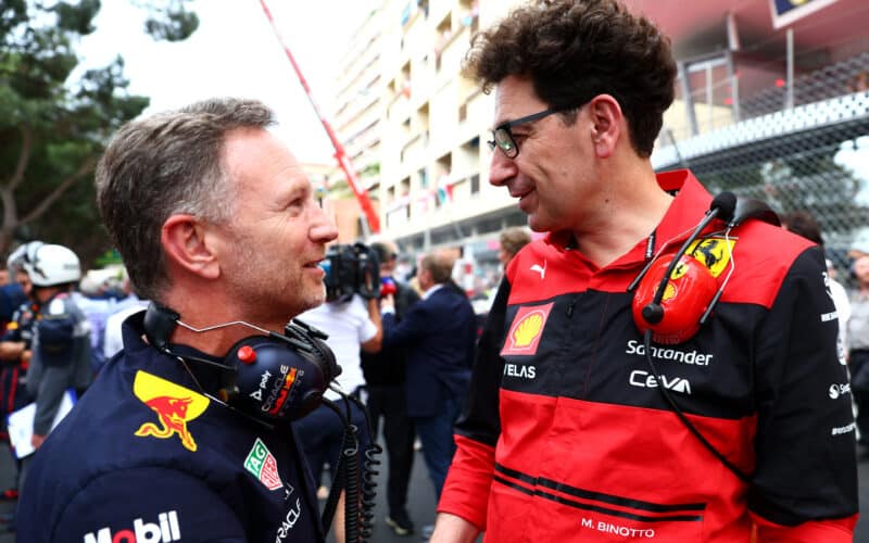 a man talking to another man in a red and black uniform