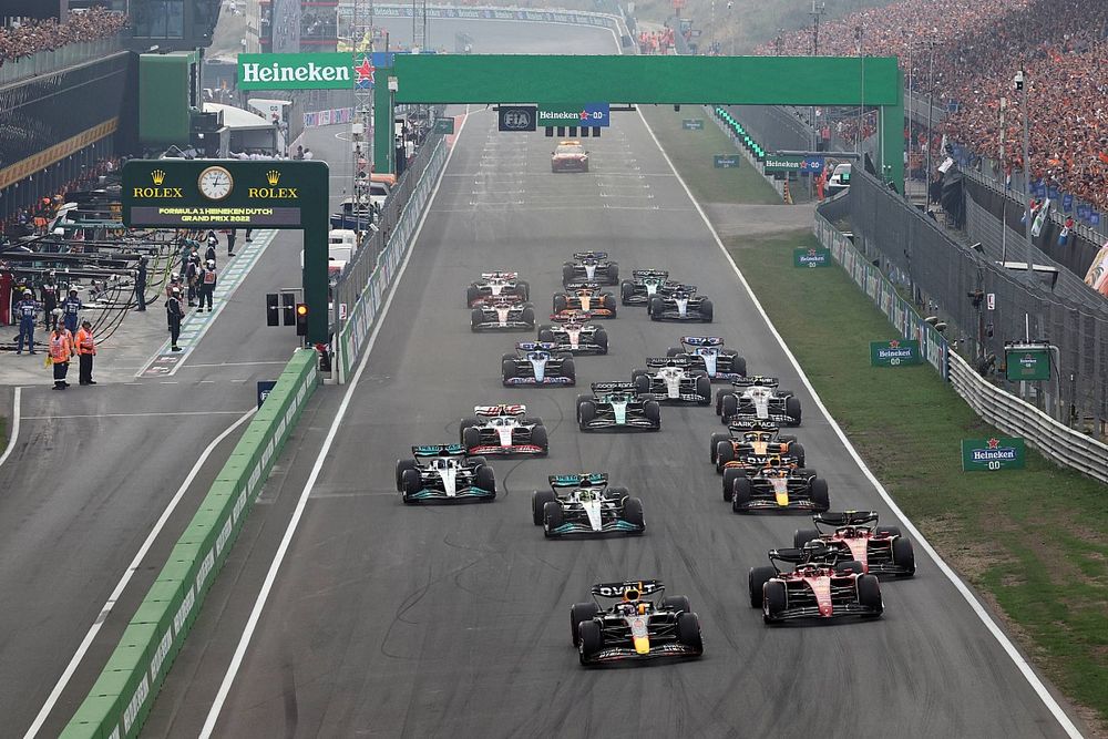 a group of cars driving down a race track