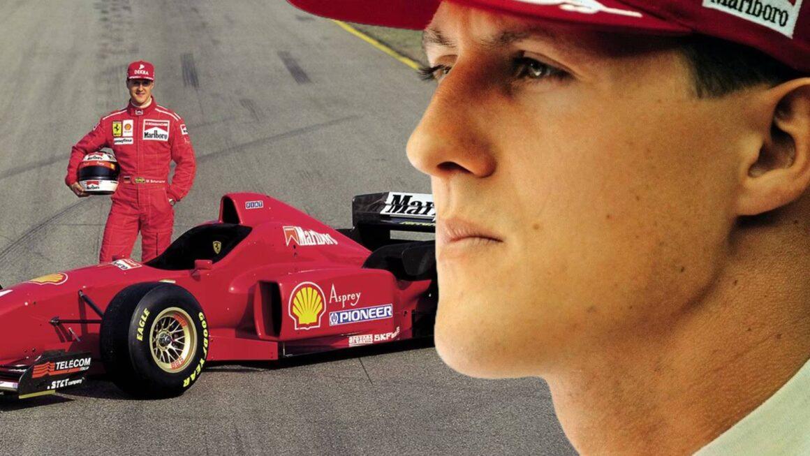 a man standing next to a red race car