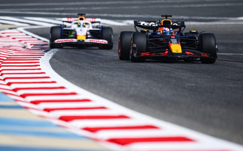 two racing cars driving on a race track